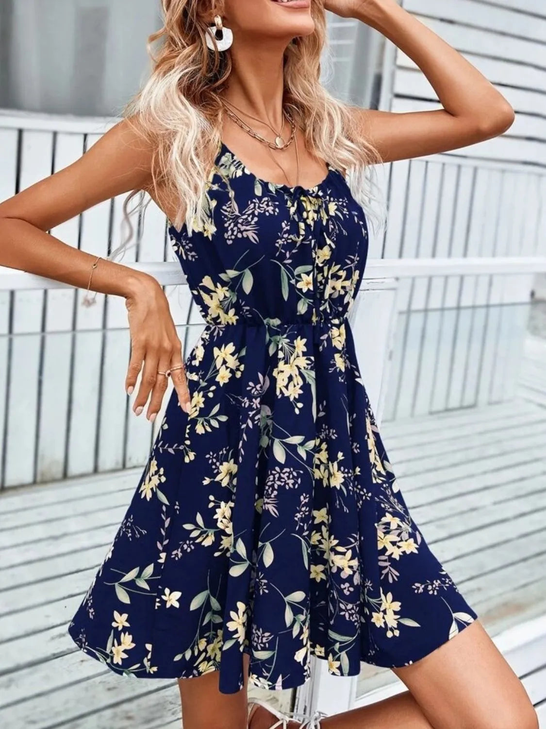 Women’s dark blue strappy tie-shoulder mini dress with yellow floral print