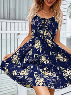 Women’s dark blue mini dress with thin straps and yellow and white floral pattern