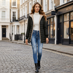 Women's black quilted winter coat with sherpa-lined collar, full-length zip front