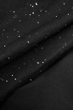 Black fabric with scattered glitter specks and smooth textured weave