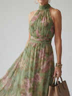 Sleeveless halter midi dress detail: sage green with pink floral pattern and ruched waist