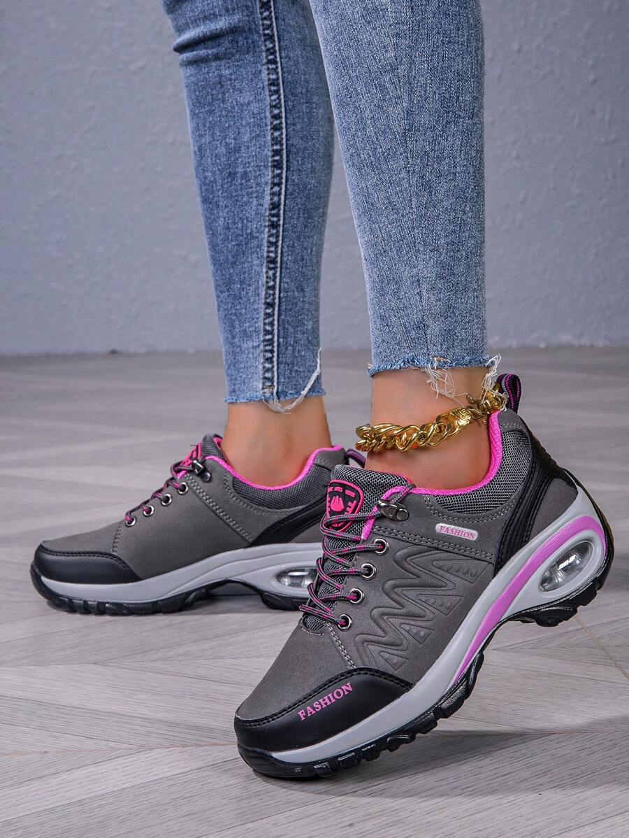Men’s hiking shoe, dark gray/black with pink collar and laces, air-cushion detail sole.