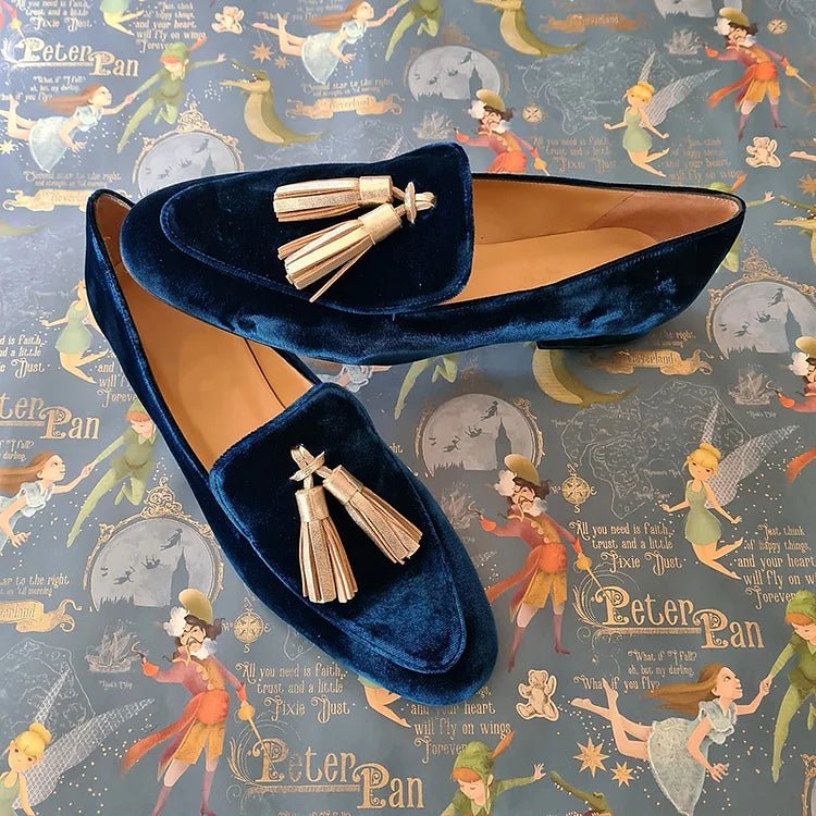 Blue velvet penny loafers with champagne tassels, rounded toe and gold hardware
