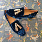 Blue velvet penny loafers with champagne tassels, rounded toe and gold hardware