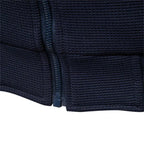 Navy zip-up jacket close-up showing textured fabric and front zipper