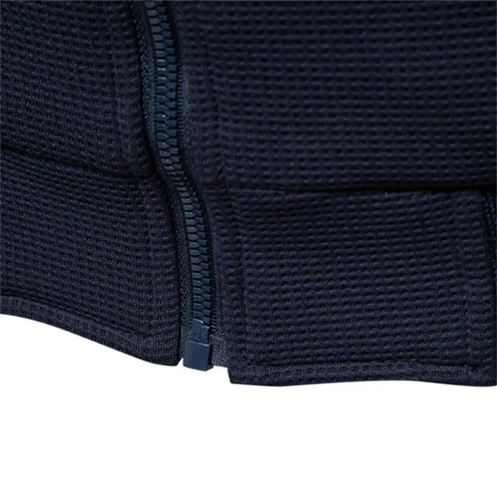 Navy zip-up jacket close-up showing textured fabric and front zipper