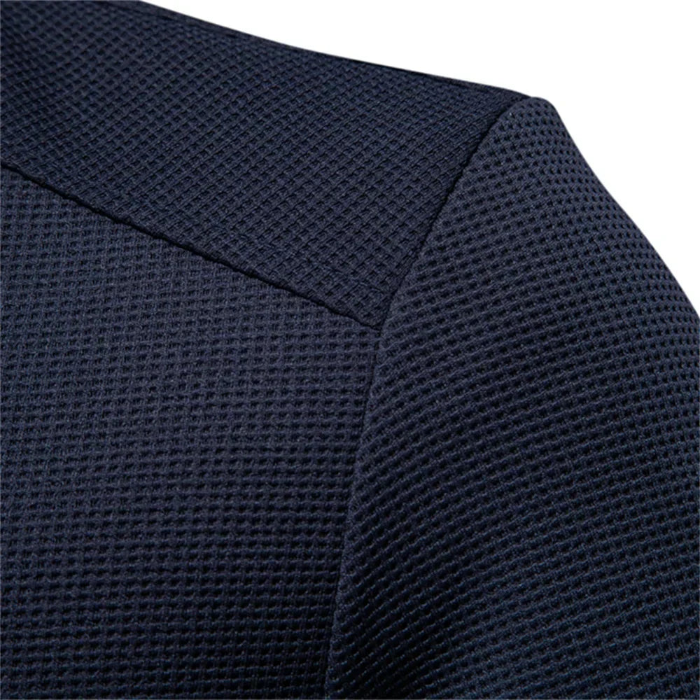 Navy jacket close-up of textured fabric and shoulder seam with stand collar