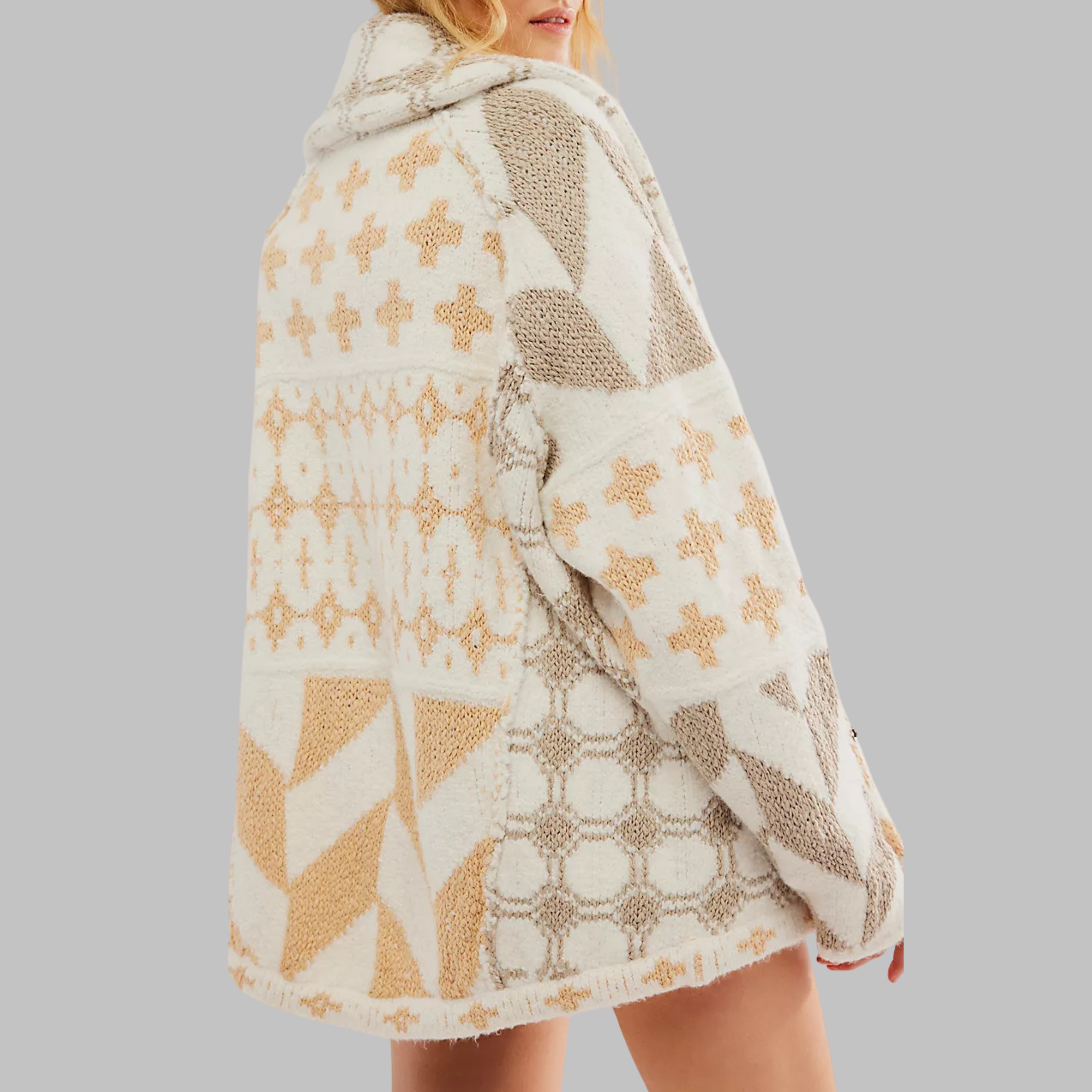 Beige oversized knit cardigan with tan geometric and cross-stitch patterns.