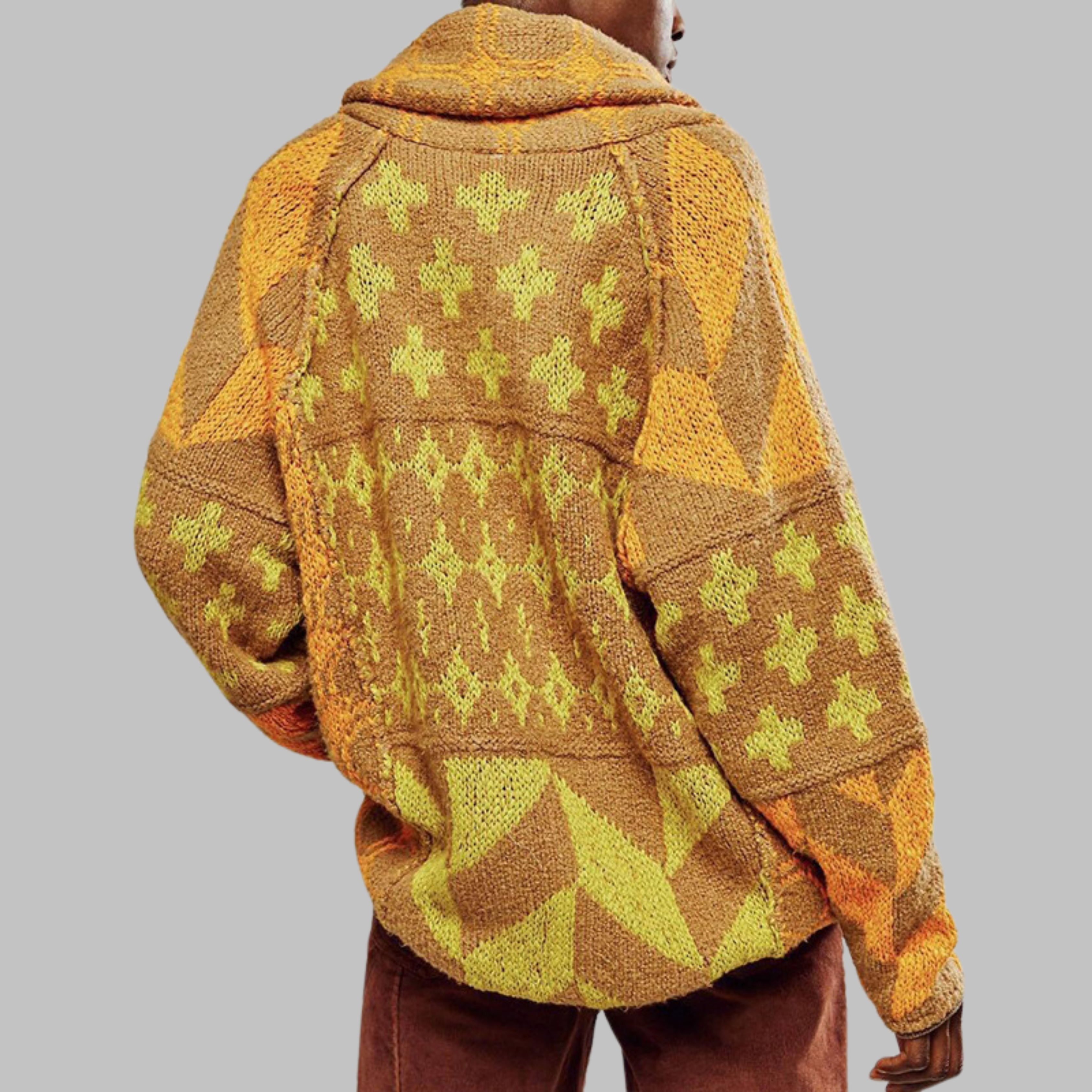 Yellow oversized knit cardigan with green cross motifs and geometric stripes.