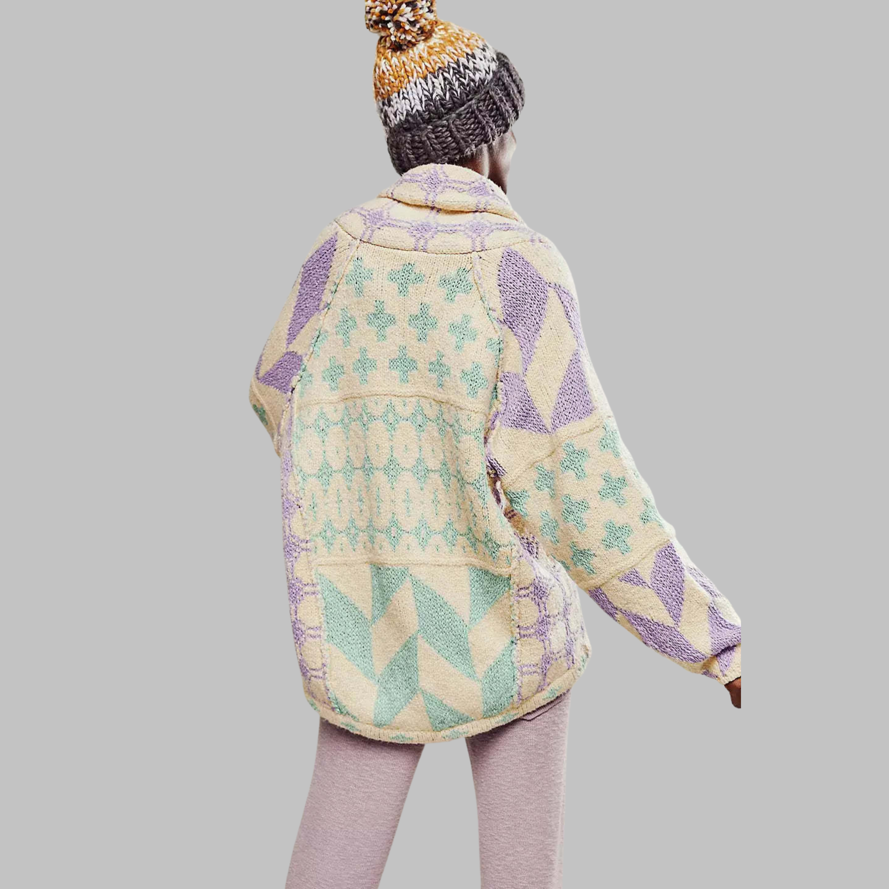 Lavender oversized knit cardigan with pastel geometric blocks and cross-stitch motifs.