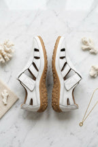 Pair of women’s white orthopaedic non-slip sandals with cutout straps and cushioned sole