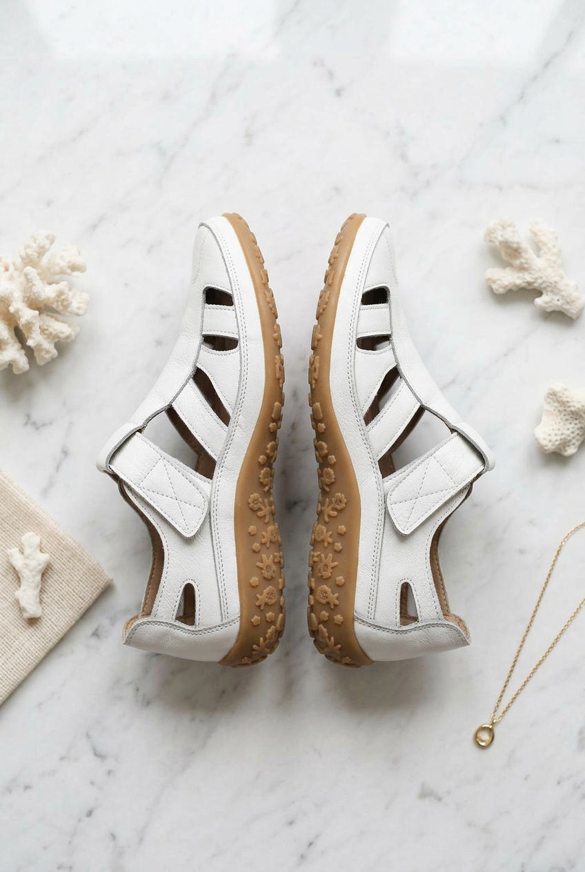Pair of women’s white orthopaedic non-slip sandals with cutout straps and cushioned sole