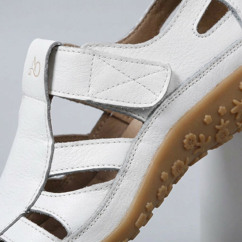 Close-up of women’s white orthopaedic non-slip sandal with hook-and-loop strap detail