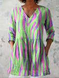 Drapey V-neck blouse in green with purple and pink abstract stripe print
