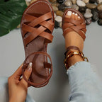 Women's brown cross-strappy flat sandals, open round toe, braided strap close-up