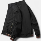 Men’s cotton bomber jacket in black shown from back with ribbed hem and sleeve cuffs