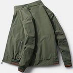 Men’s cotton bomber jacket in green shown from back with ribbed hem and sleeve cuffs