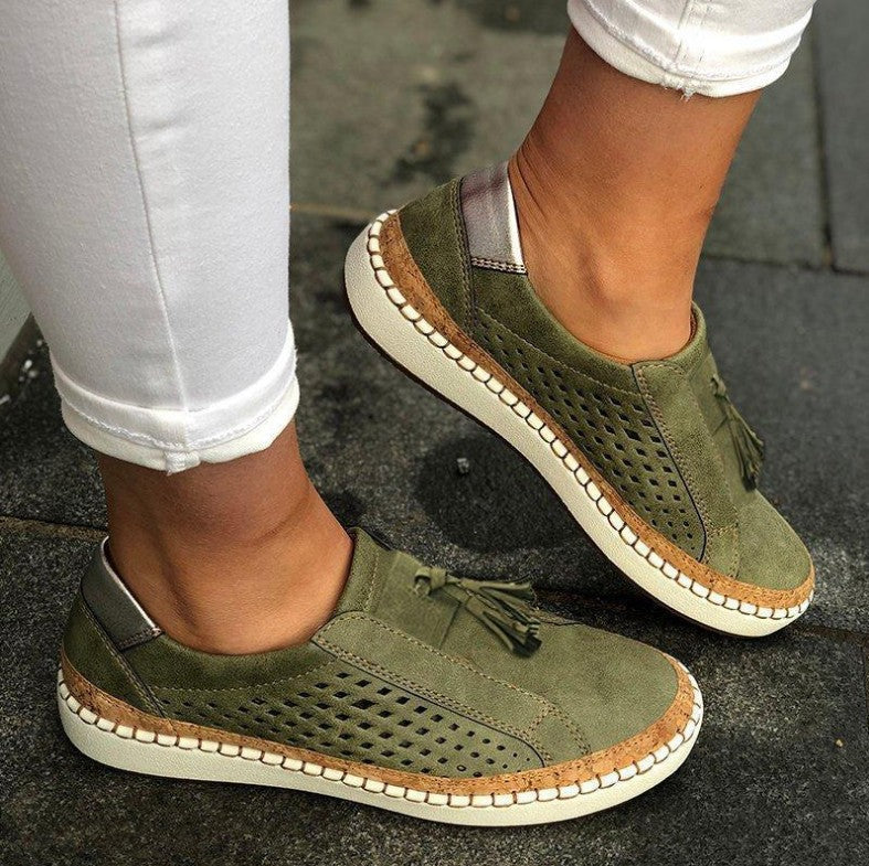 Women's green slip-on textile slippers with tassel detail and stitched rubber sole