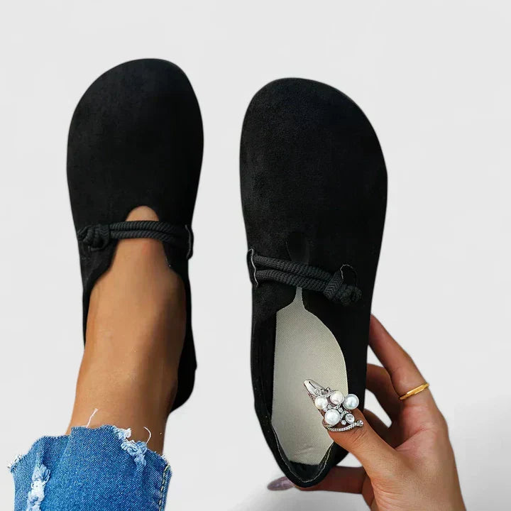 Black cushioned slip-on loafers with round toe and elastic strap, side view
