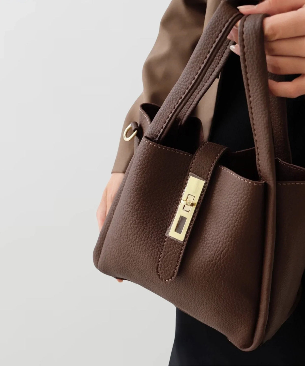 Brown leather-look crossbody bag with front pocket tab and gold-tone clasp hardware