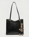 Black vegan leather small crossbody tote bag with top handles and bunny charm keychain.