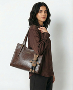 Brown vegan leather small crossbody tote with top handles and bunny charm keychain.