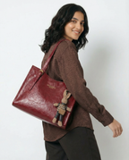 Wine red vegan leather small crossbody tote bag with top handles and bunny charm keychain.