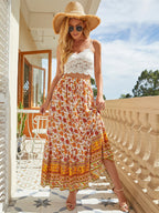 Bohemian floral A-line maxi skirt with elastic high waist, tiered border hem, orange print.