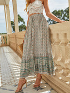 Bohemian floral A-line maxi skirt with elastic high waist, tiered border hem, teal patterned hem.