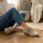 Beige ankle boots with pointed toe, block heel, and side zip for cushioned comfort