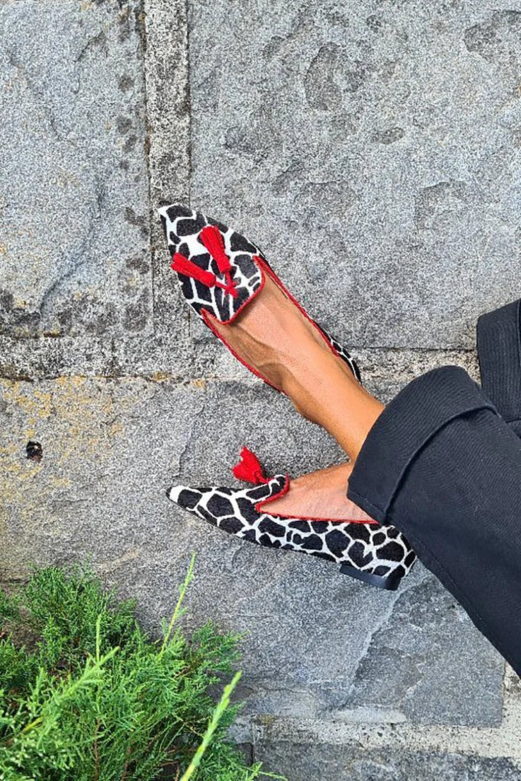 Women's animal print loafers with red fringes, black-and-white pattern