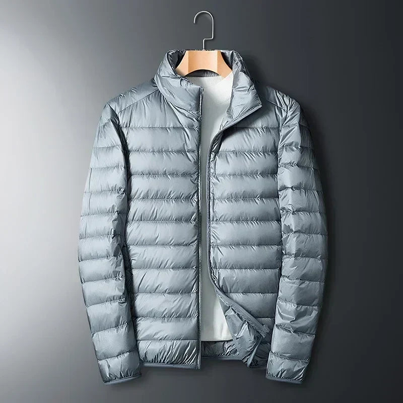 Light gray waterproof puffer jacket with full-zip front and stand collar.