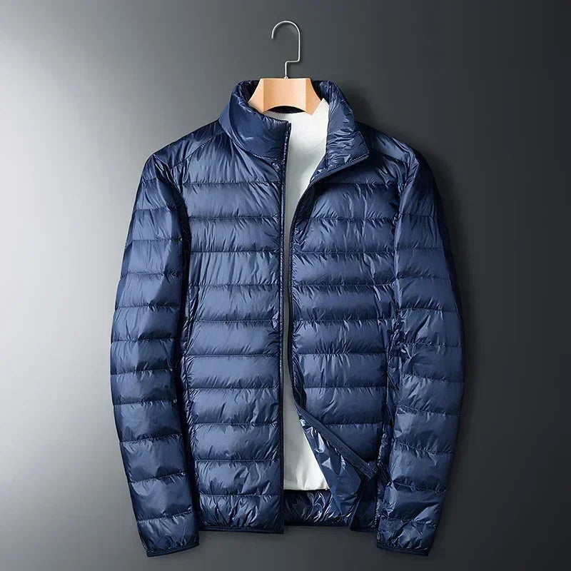Navy waterproof puffer jacket with full-zip front and stand collar.