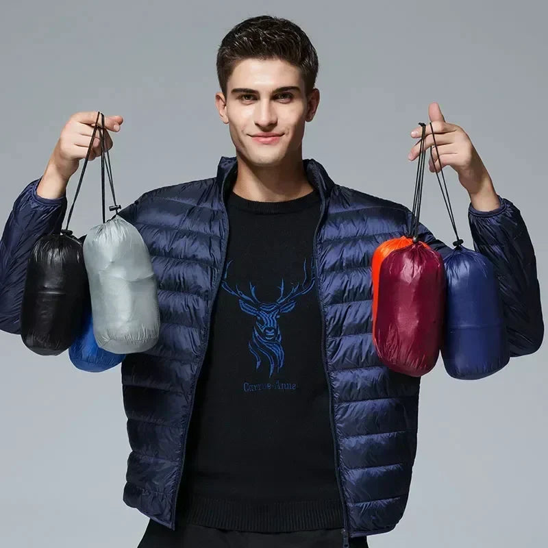 Navy waterproof puffer jacket on model, with full-zip front and stand collar.