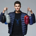 Navy waterproof puffer jacket on model, with full-zip front and stand collar.