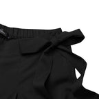 Black high-waisted trousers with gathered waist and side bow tie detail