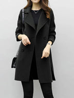 Black longline coat with notch lapels, button front, and long sleeves