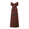 Off-shoulder pleated maxi dress with draped neckline, red leaf print on dark base
