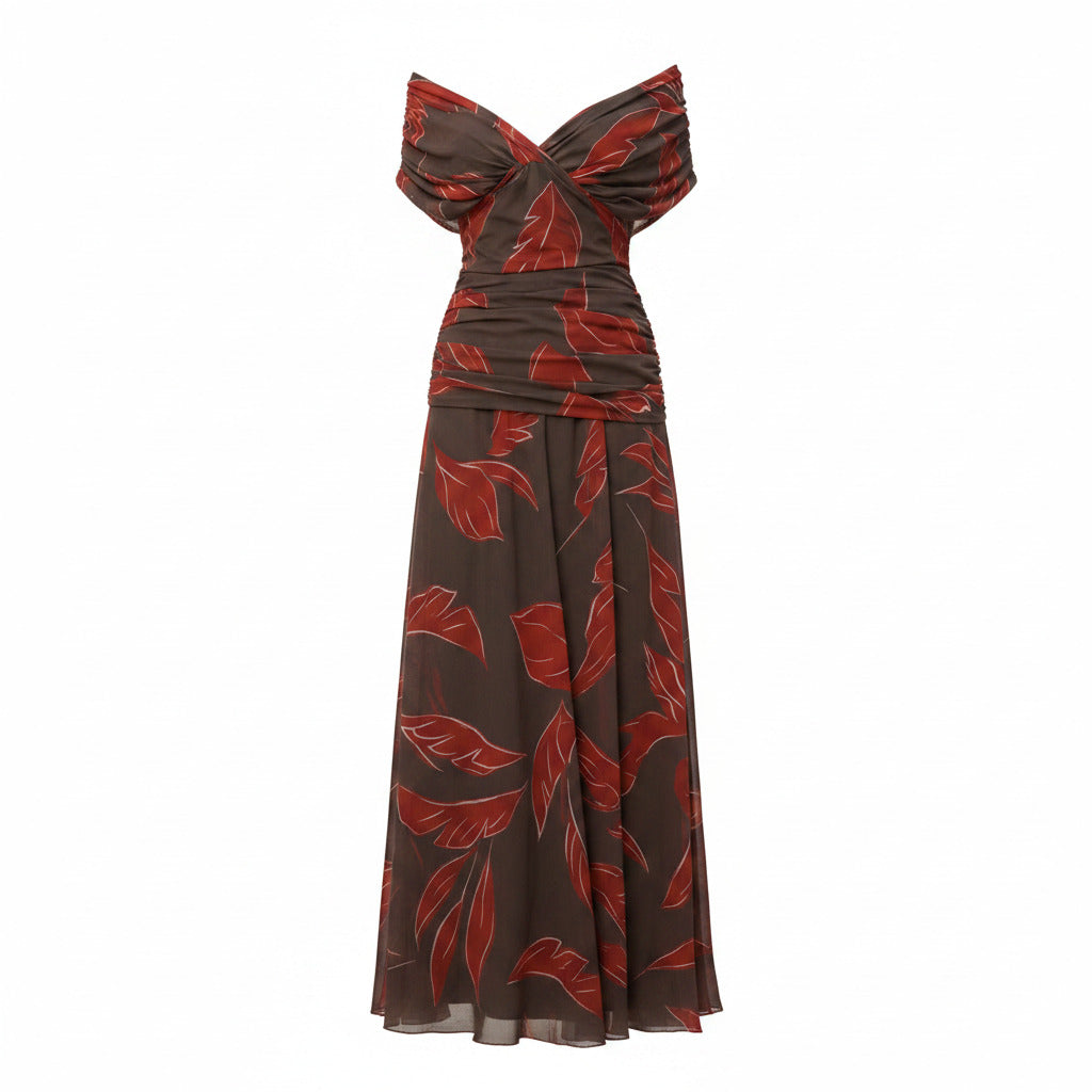 Off-shoulder pleated maxi dress with draped neckline, red leaf print on dark base