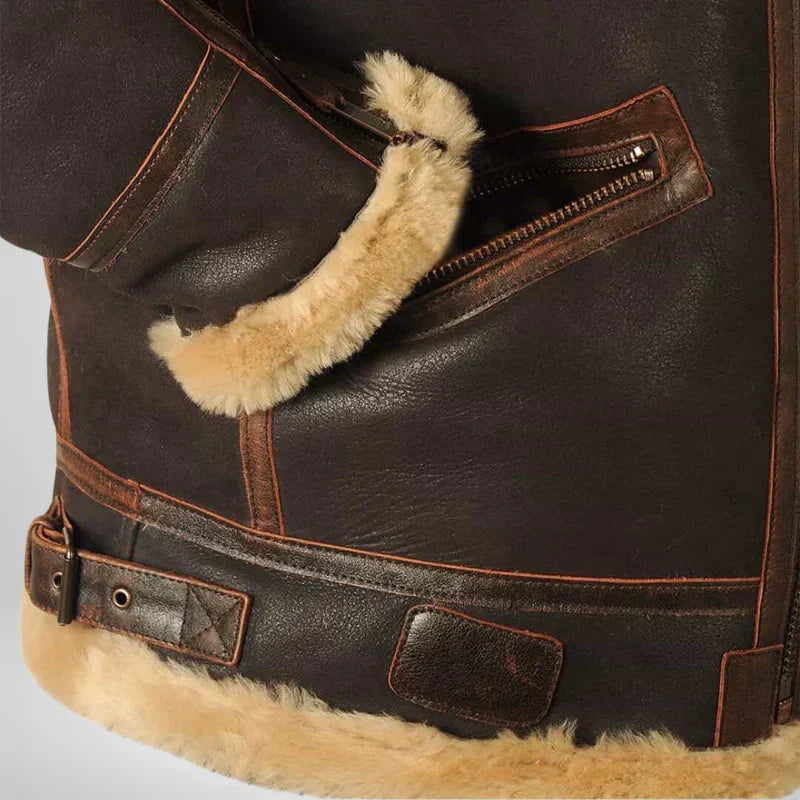 Brown leather jacket detail with tan fur cuffs, zip pocket and belt strap
