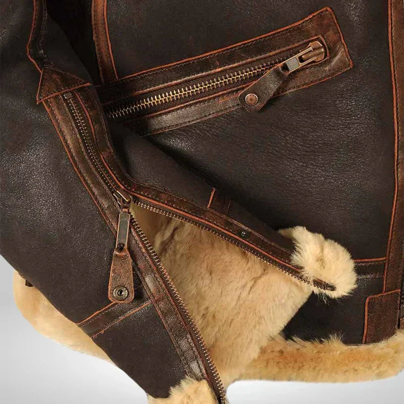 Brown leather jacket detail showing zipper closure and tan fur-trim lining