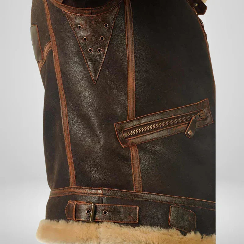 Brown leather flight jacket detail with grommeted strap panel and fur-trim hem