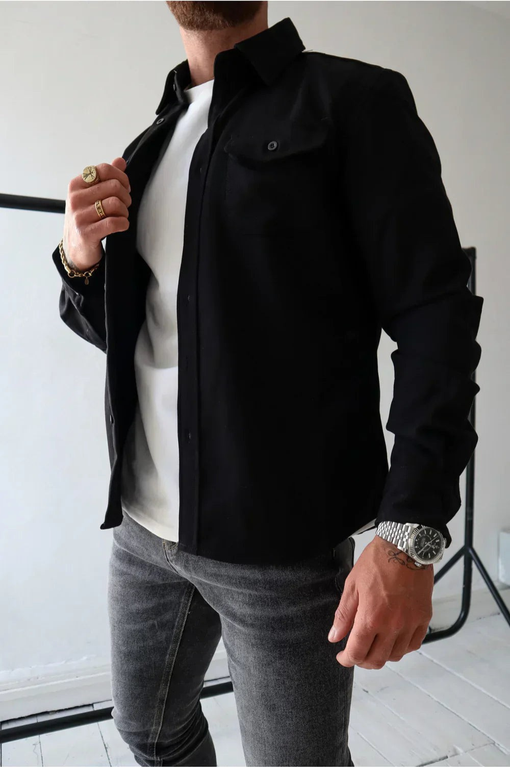 Black men’s button-front overshirt with flap chest pockets and long sleeves