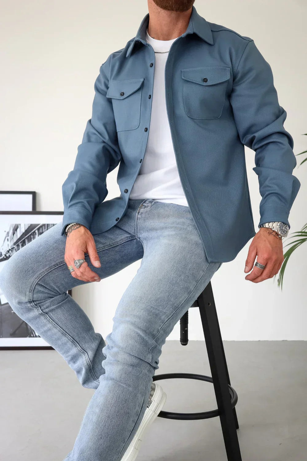 Blue men’s casual overshirt with button front and flap chest pockets, long sleeves