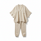 Apricot two-piece batwing blouse and relaxed joggers set, flat lay