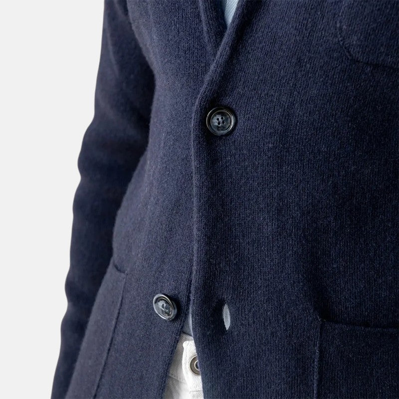 Men's navy blazer jacket close-up of lapel and buttons over shirt
