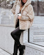Apricot hooded puffer coat with faux-fur trim, front zipper, and ribbed cuffs