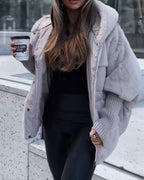 Light gray hooded puffer coat with faux-fur trim and full-length front zipper