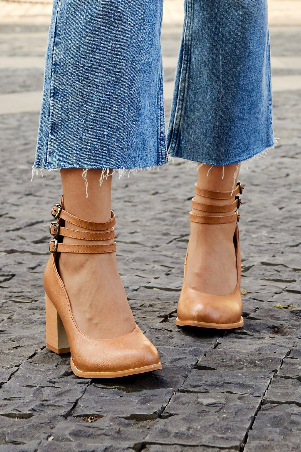 Brown triple-buckle block heel ankle strap pumps, side view with three buckle bands.