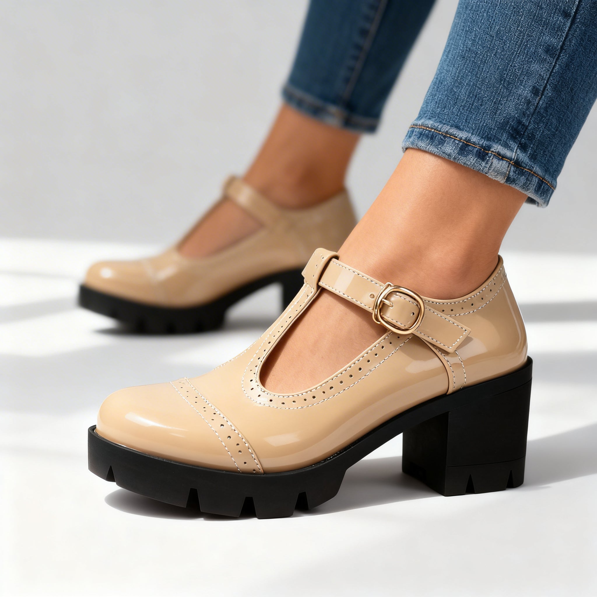 Beige Mary Jane T-bar heels with ankle strap, gold buckle, and chunky sole